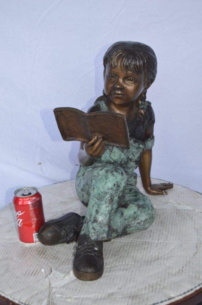 Young Girl Laying and Reading Book Bronze Statue - Size: 18" L x 9" W x 16" H.